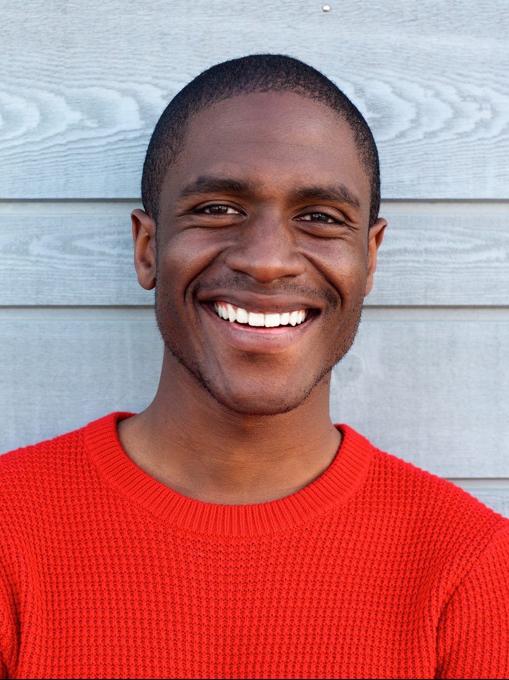close-up-smiling-young-black-guy-in-red-sweater-e1637383598973.jpg